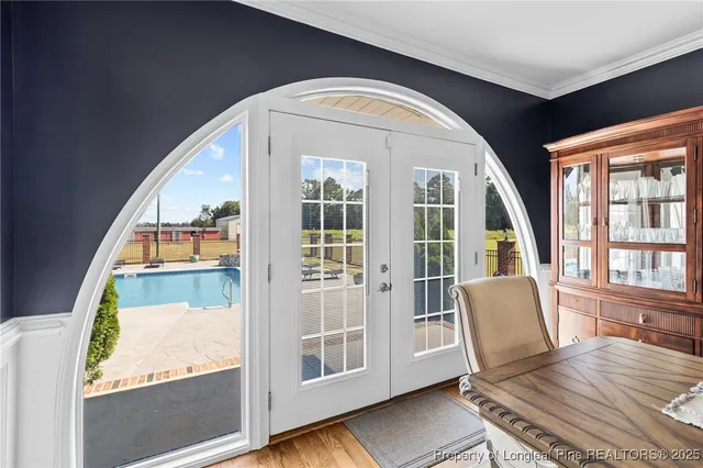 a view of a bedroom with wooden floor and windows