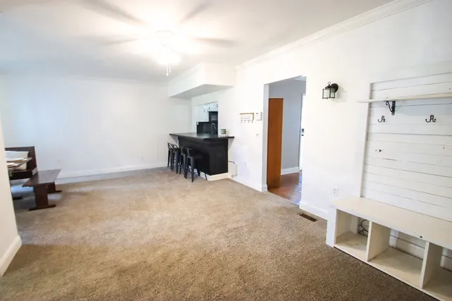 a view of livingroom with furniture and a refrigerator