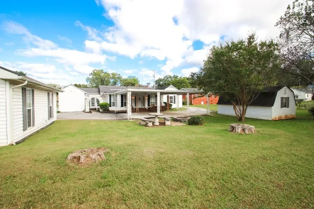 a view of a house with backyard porch and sitting area