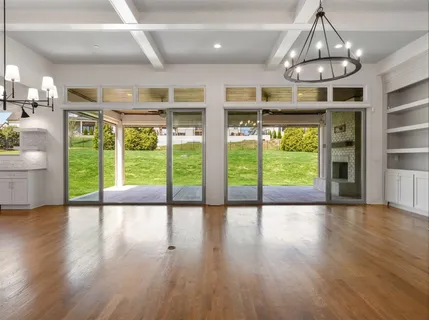 a kitchen with stainless steel appliances granite countertop a sink a stove and a wooden floors
