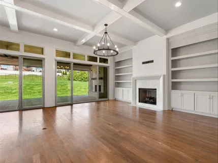 a kitchen with stainless steel appliances granite countertop a sink a stove a refrigerator and island with wooden floor