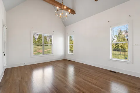 a view of an empty room with a fireplace and a porch