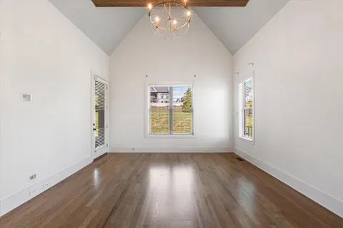 a view of an empty room with a fireplace and a window