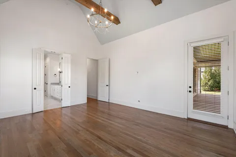 a view of an empty room with a fireplace and a window