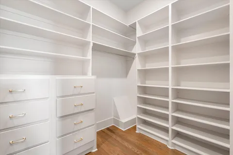 a bathroom with a toilet a sink a mirror and shower