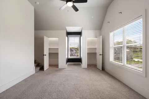 a view of a house with a big yard and large trees