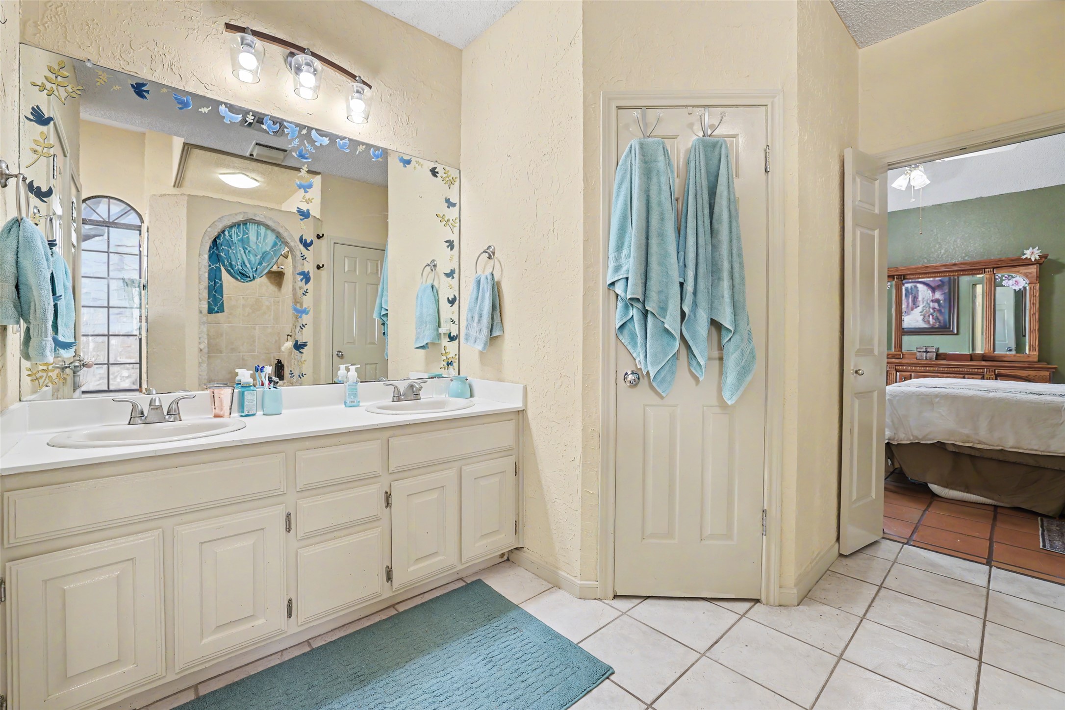 110 South Ridge Circle Georgetown, TX 78628 - Photo 17 of 37 Bathroom vanity featuring dual undermount sinks, a laminate countertop, and ample cabinet storage