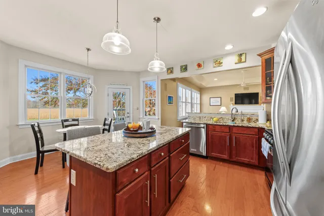 a kitchen with stainless steel appliances granite countertop microwave stove top oven and refrigerator