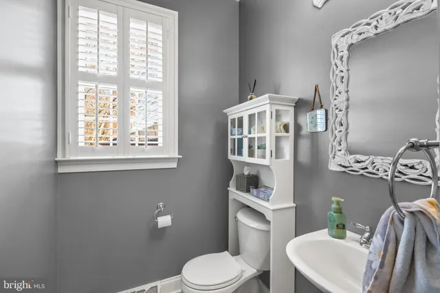 a white toilet sitting next to a bathroom sink