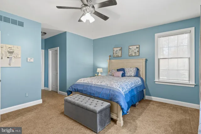 a bedroom with a bed couch and window