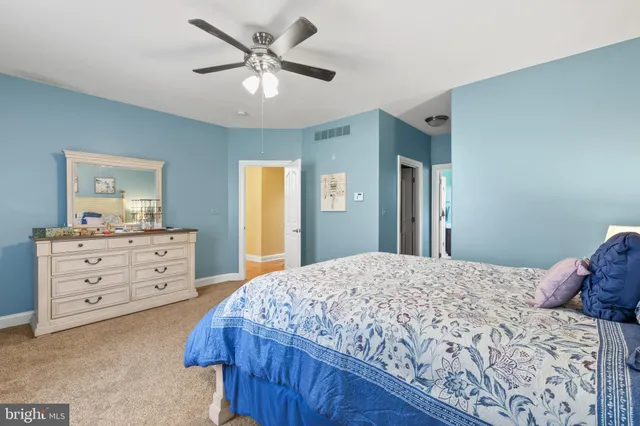 a bedroom with a bed and a dresser in it