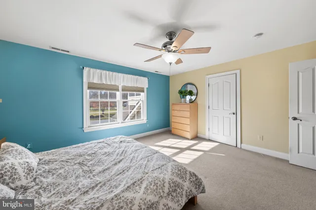 a view of a bedroom with natural light and windows