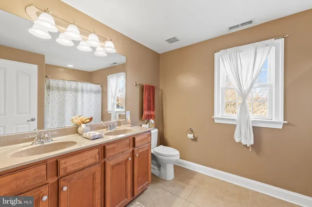 a bathroom with a double vanity sink and a mirror