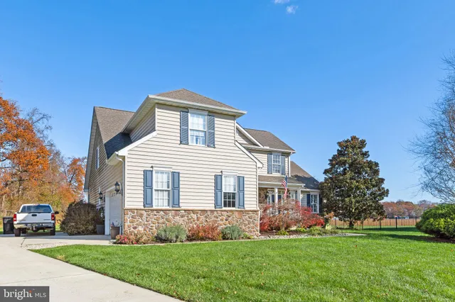 a front view of house with yard and green space