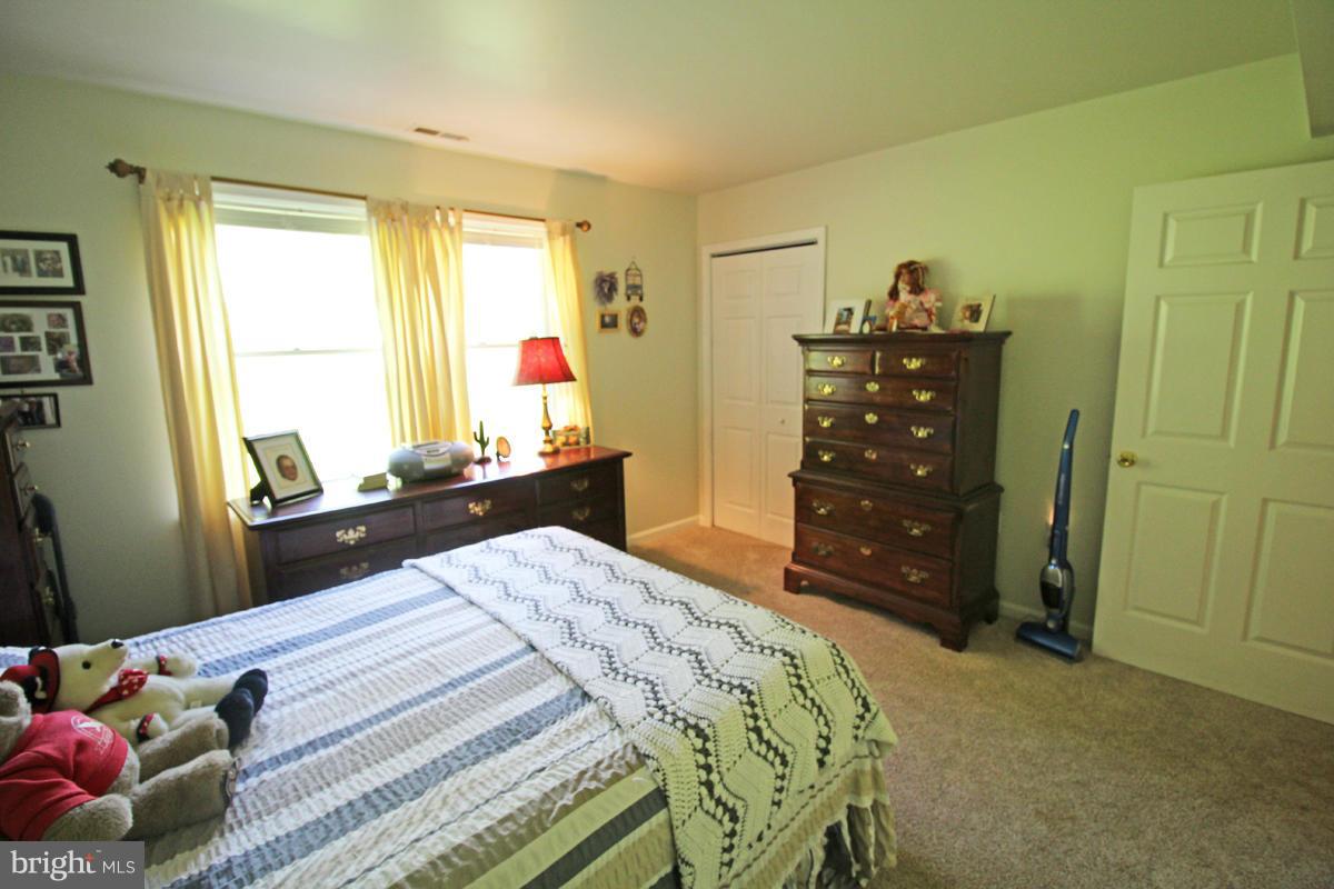 11920 Liberty Road, Unit 106B Frederick, MD 21701 - Photo 11 of 15 a bedroom with a bed and a dresser