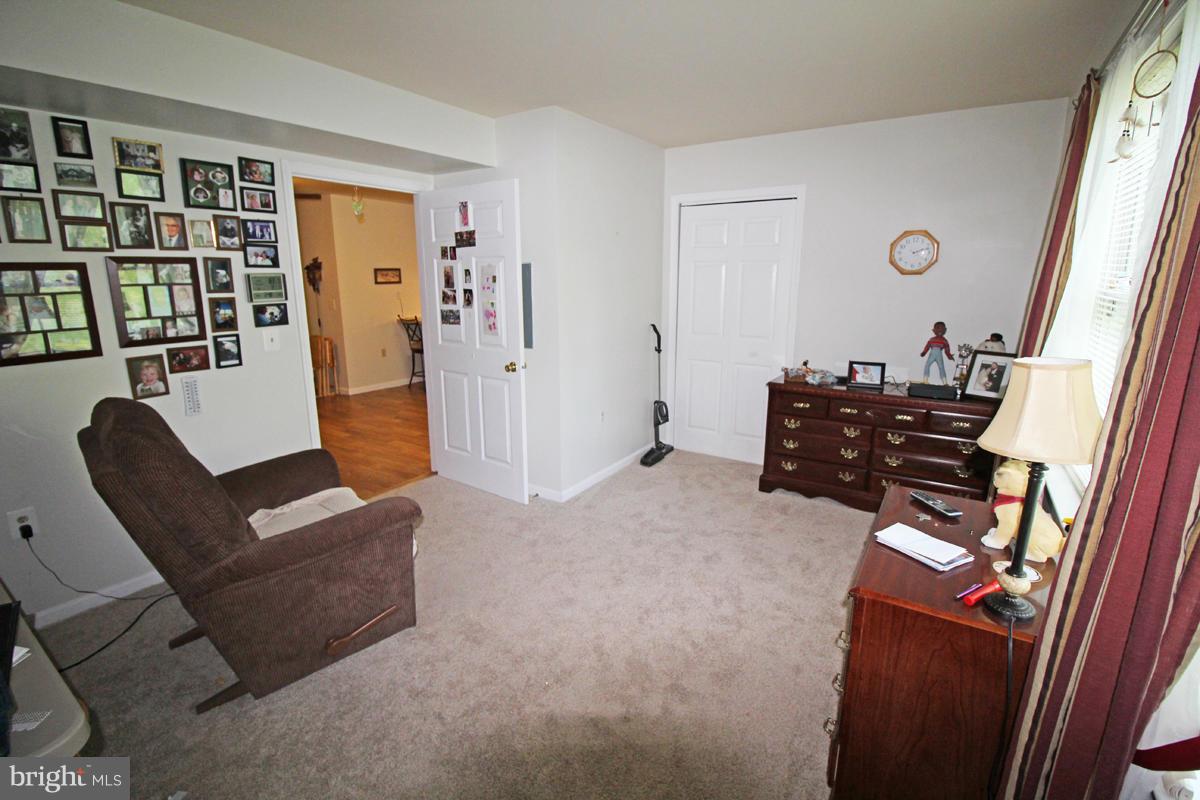 11920 Liberty Road, Unit 106B Frederick, MD 21701 - Photo 13 of 15 a living room with furniture and a book shelf