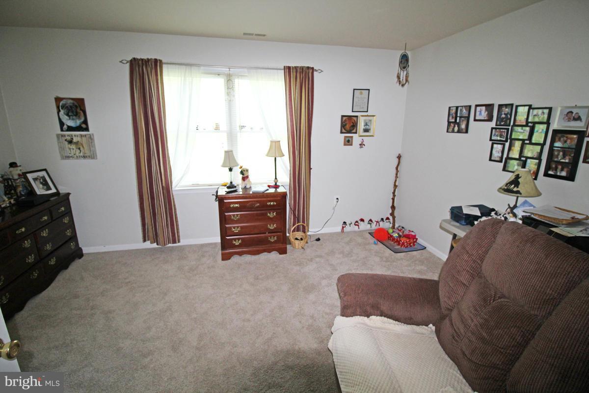 11920 Liberty Road, Unit 106B Frederick, MD 21701 - Photo 14 of 15 a bedroom with furniture and a window