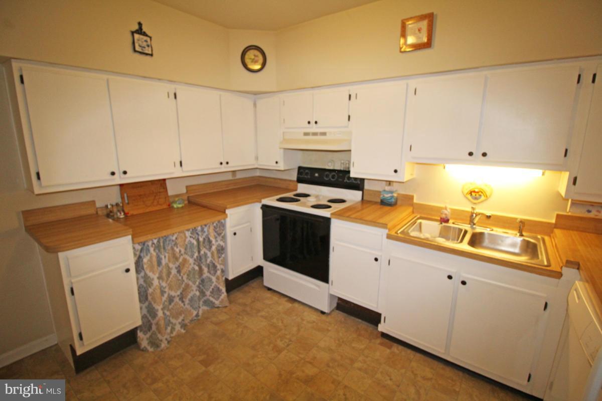 11920 Liberty Road, Unit 106B Frederick, MD 21701 - Photo 6 of 15 a kitchen with a sink stove and cabinets