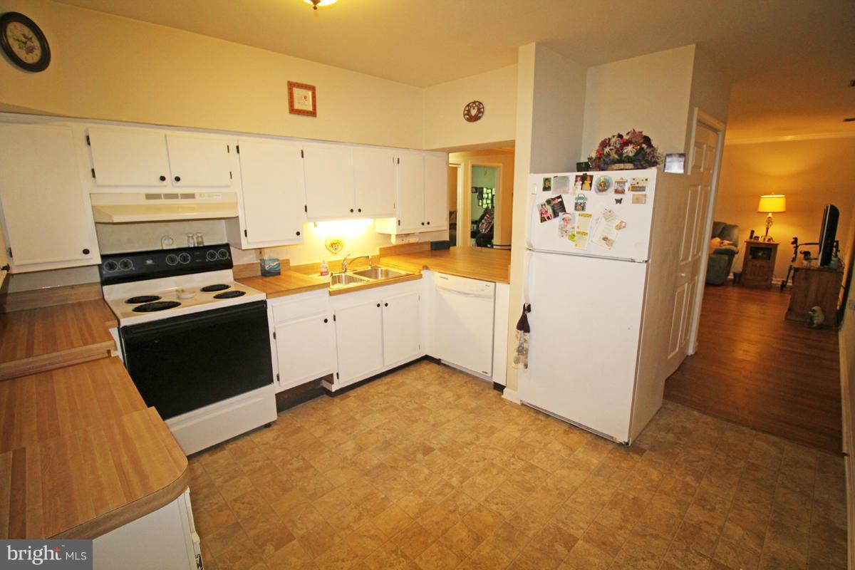 11920 Liberty Road, Unit 106B Frederick, MD 21701 - Photo 7 of 15 a kitchen with cabinets and appliances
