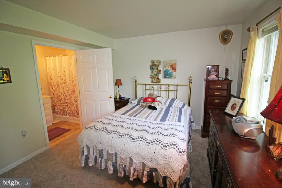 11920 Liberty Road, Unit 106B Frederick, MD 21701 - Photo 9 of 15 a bed room with a bed and a desk
