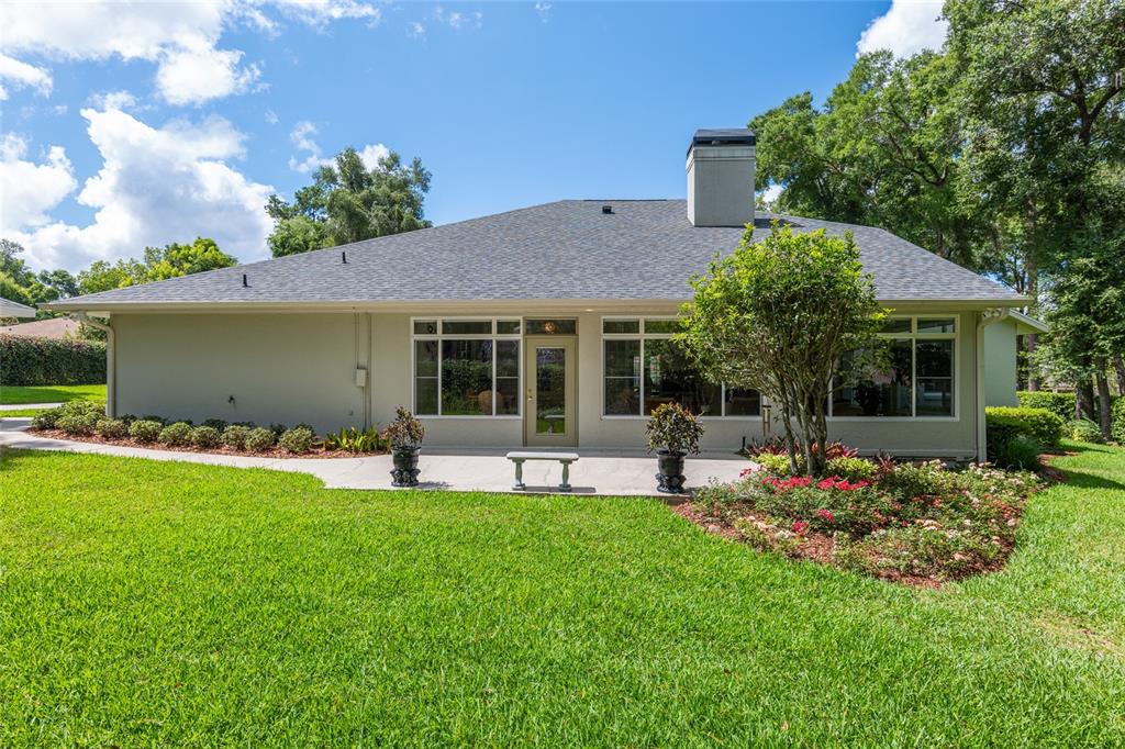 2215 Spring Hill Court Ocala, FL 34471 - Photo 52 of 62 a front view of house with a garden and patio