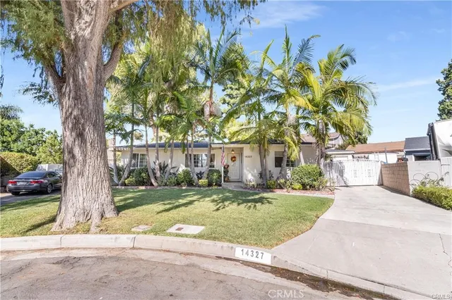 front view of a house with a tree in a yard