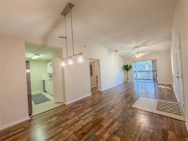 a view of a room with wooden floor and windows
