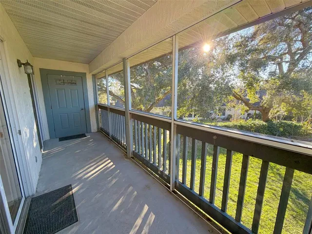 a view of a porch with wooden floor