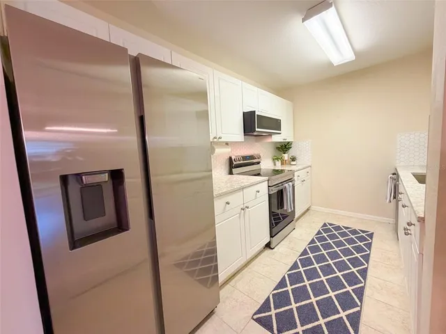 a kitchen with a stove a sink and a refrigerator