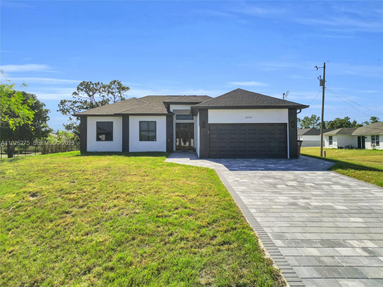 a front view of a house with a garden and yard