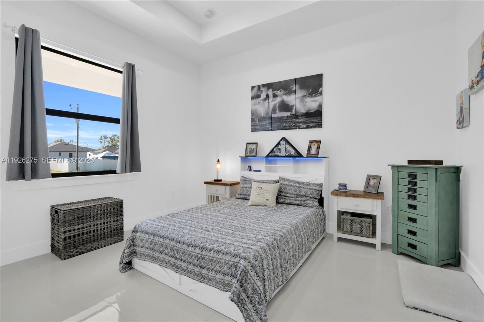 2250 10th Terrace Lehigh Acres, FL 33936 - Photo 11 of 39 a bedroom with a bed and a painting on the wall