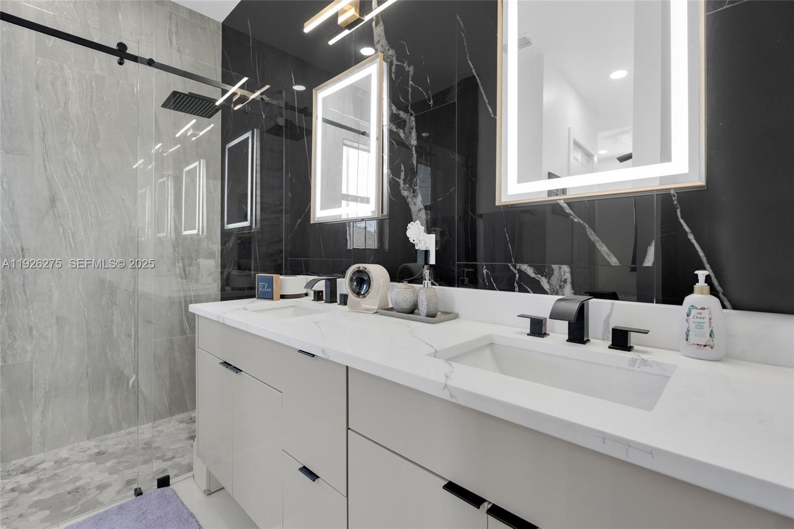 2250 10th Terrace Lehigh Acres, FL 33936 - Photo 14 of 39 a bathroom with a sink and a mirror