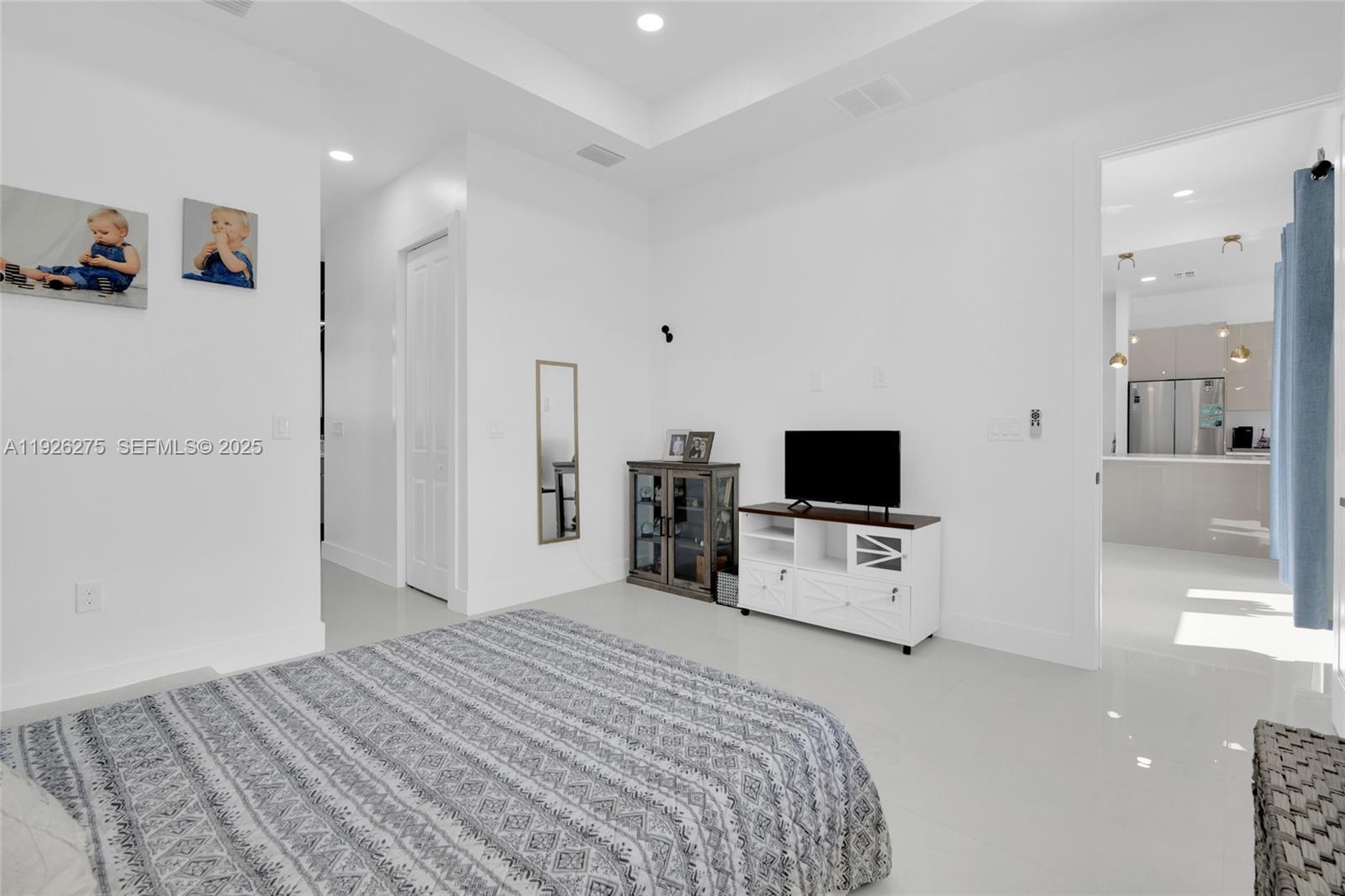 2250 10th Terrace Lehigh Acres, FL 33936 - Photo 16 of 39 a bedroom with a bed and a television