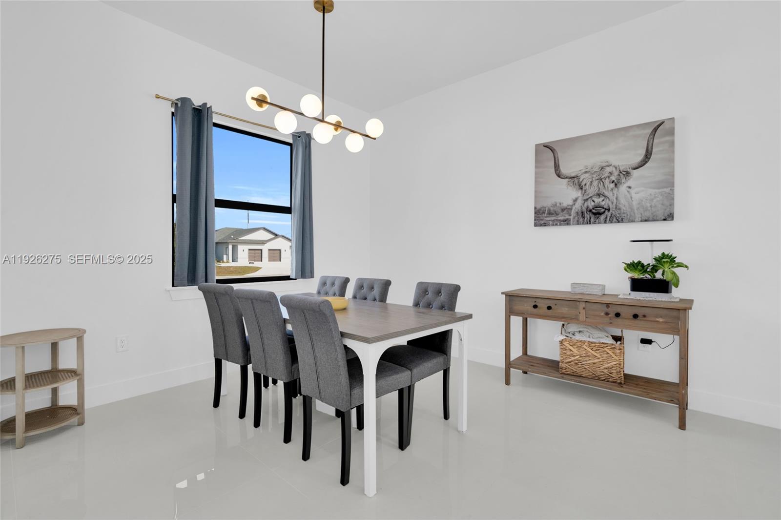 2250 10th Terrace Lehigh Acres, FL 33936 - Photo 20 of 39 a view of a dining room with furniture and chandelier