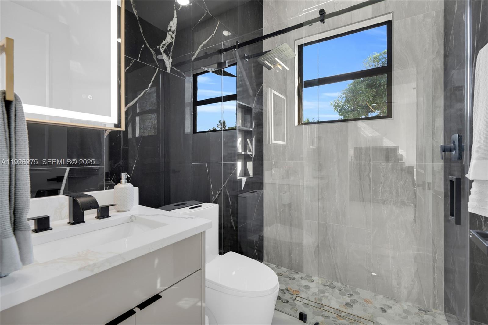 2250 10th Terrace Lehigh Acres, FL 33936 - Photo 21 of 39 a bathroom with a sink a toilet and shower