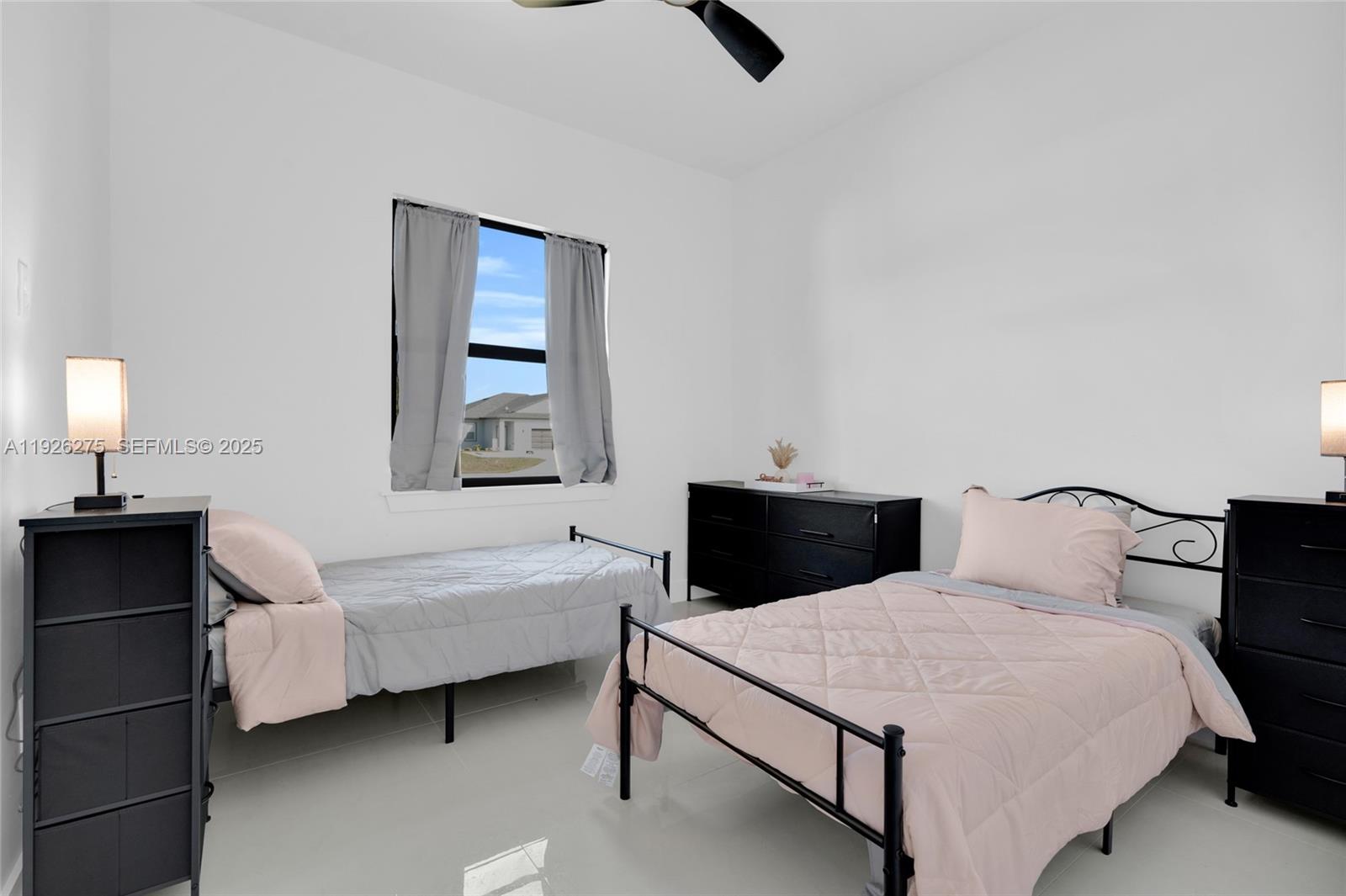 2250 10th Terrace Lehigh Acres, FL 33936 - Photo 22 of 39 a bedroom with a bed and window