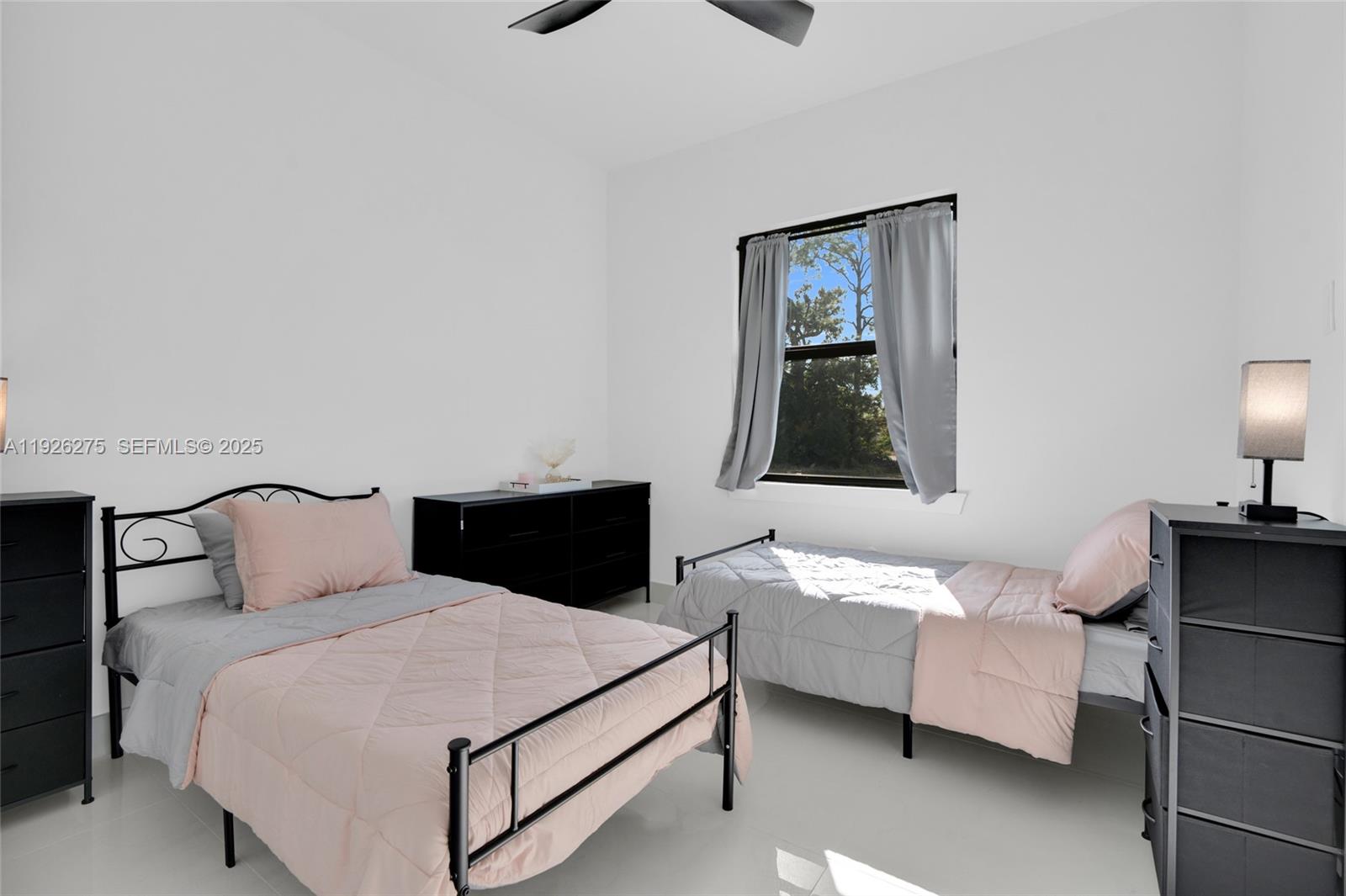 2250 10th Terrace Lehigh Acres, FL 33936 - Photo 23 of 39 a bedroom with a bed and window