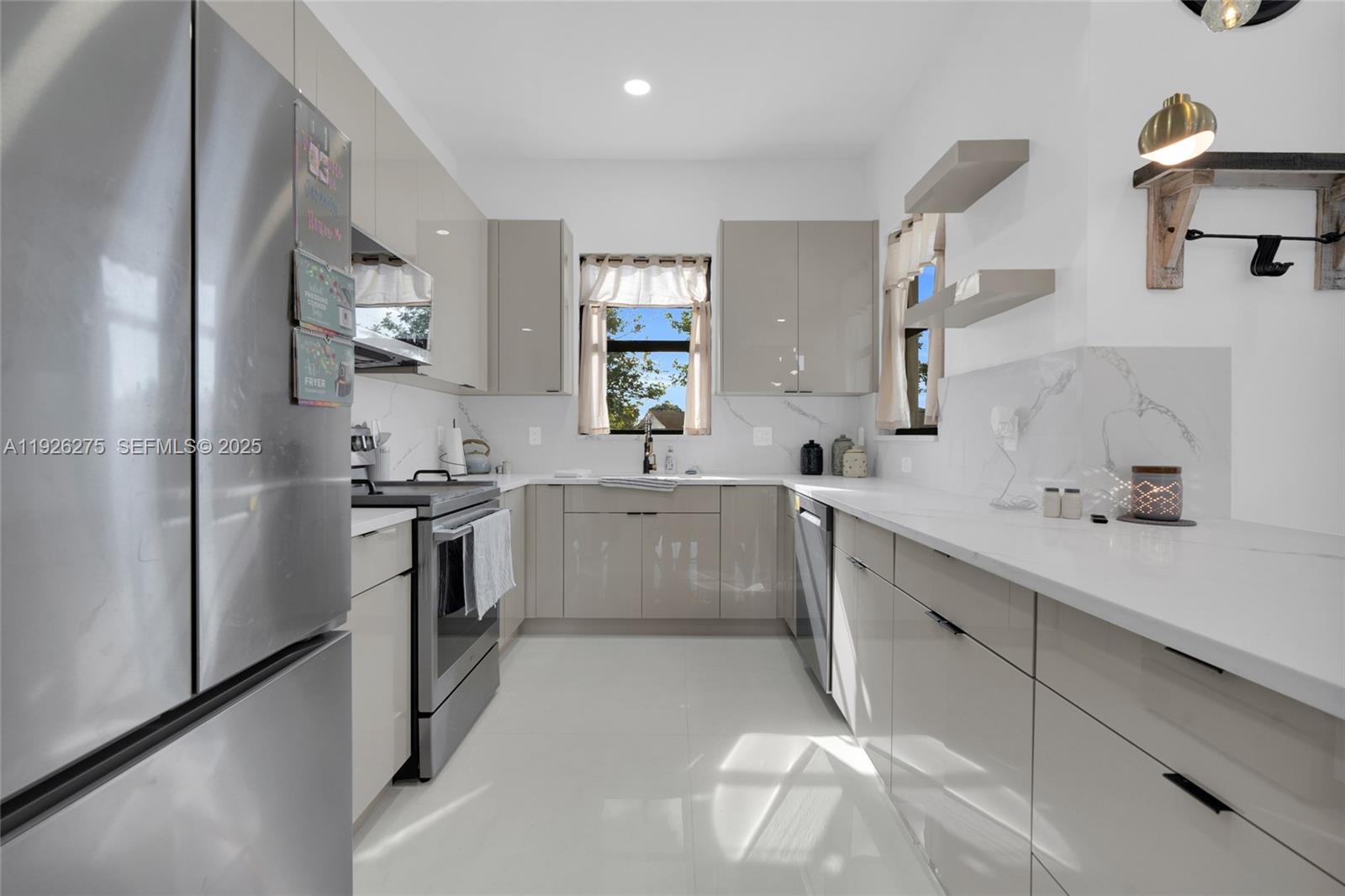 2250 10th Terrace Lehigh Acres, FL 33936 - Photo 25 of 39 a kitchen with white cabinets and appliances