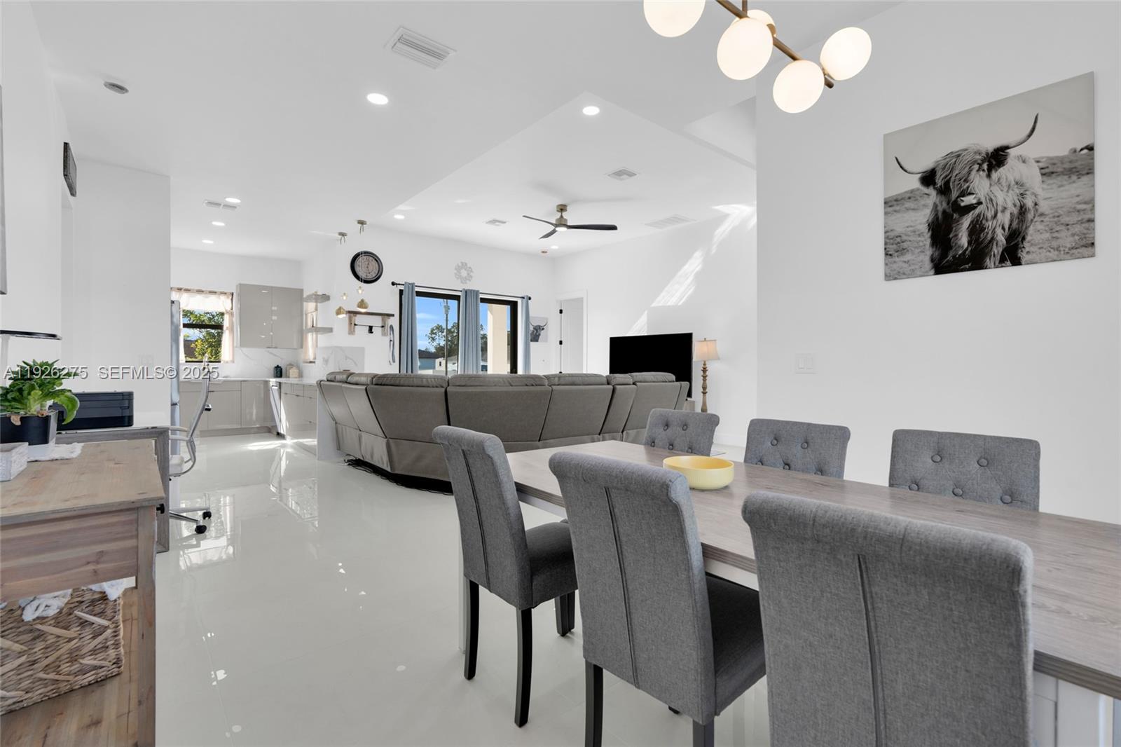 2250 10th Terrace Lehigh Acres, FL 33936 - Photo 26 of 39 a living room with furniture and a chandelier