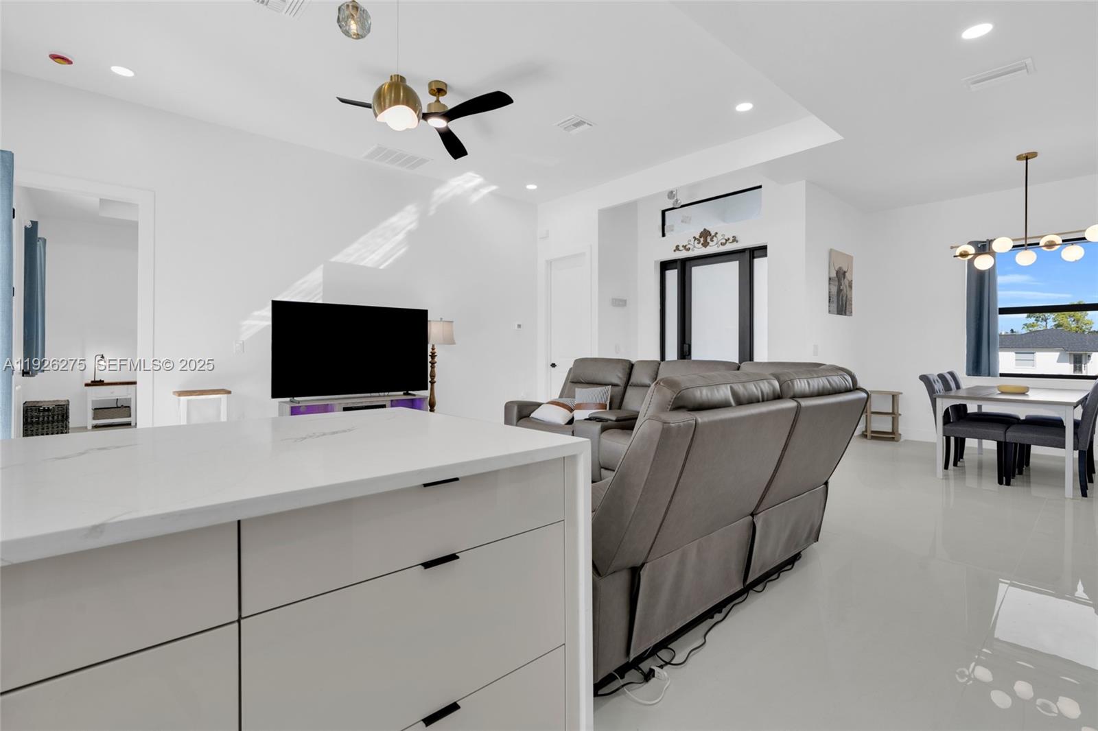 2250 10th Terrace Lehigh Acres, FL 33936 - Photo 30 of 39 a living room with furniture and a flat screen tv