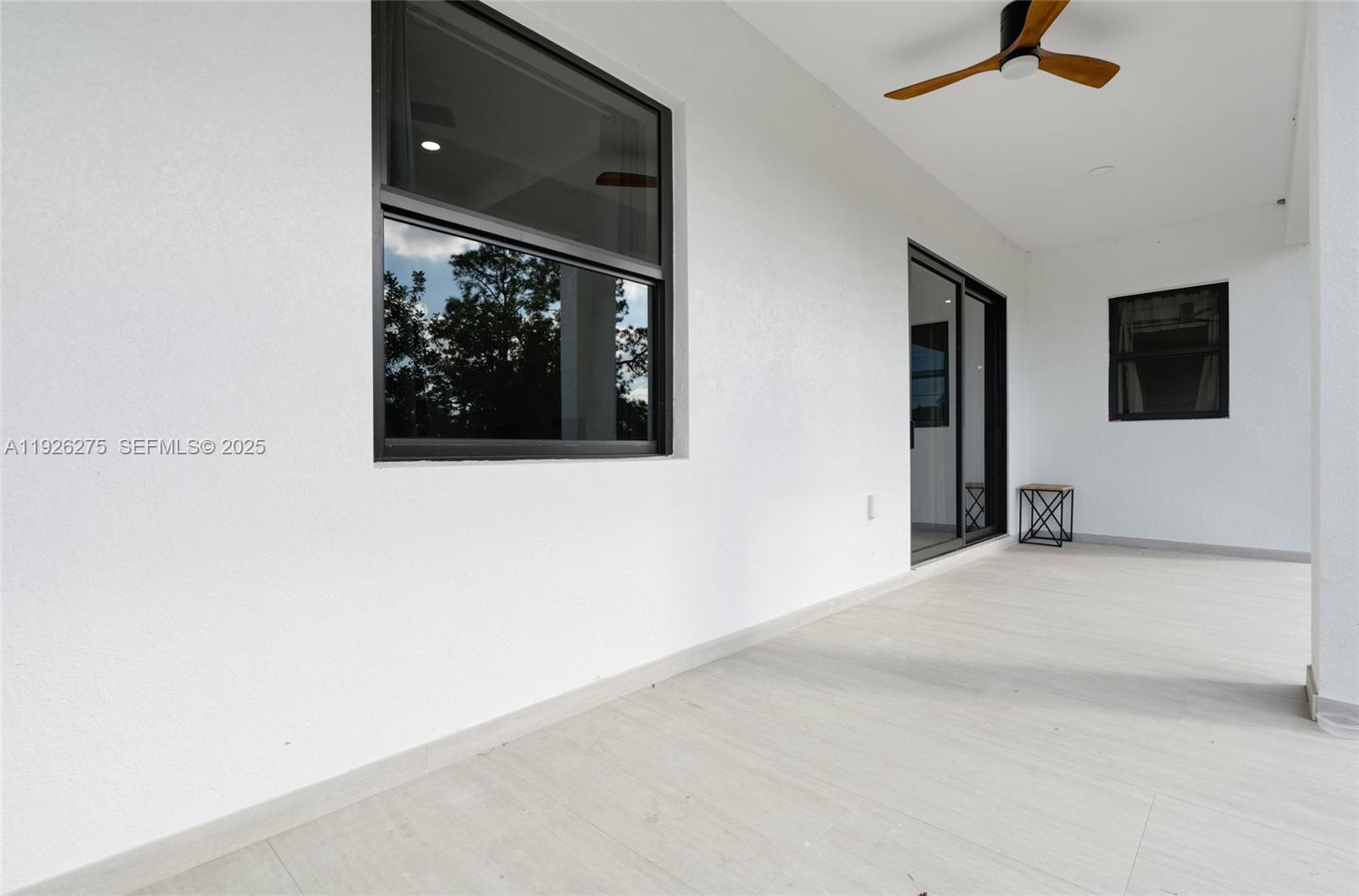 2250 10th Terrace Lehigh Acres, FL 33936 - Photo 31 of 39 a view of a livingroom with a ceiling fan and window