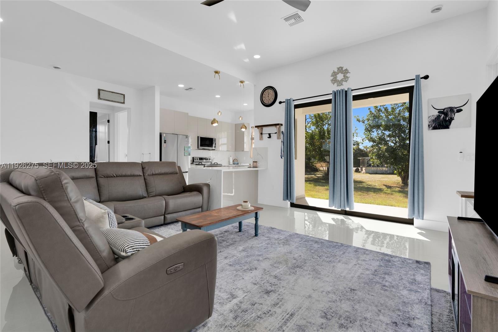 2250 10th Terrace Lehigh Acres, FL 33936 - Photo 8 of 39 a living room with furniture and large windows