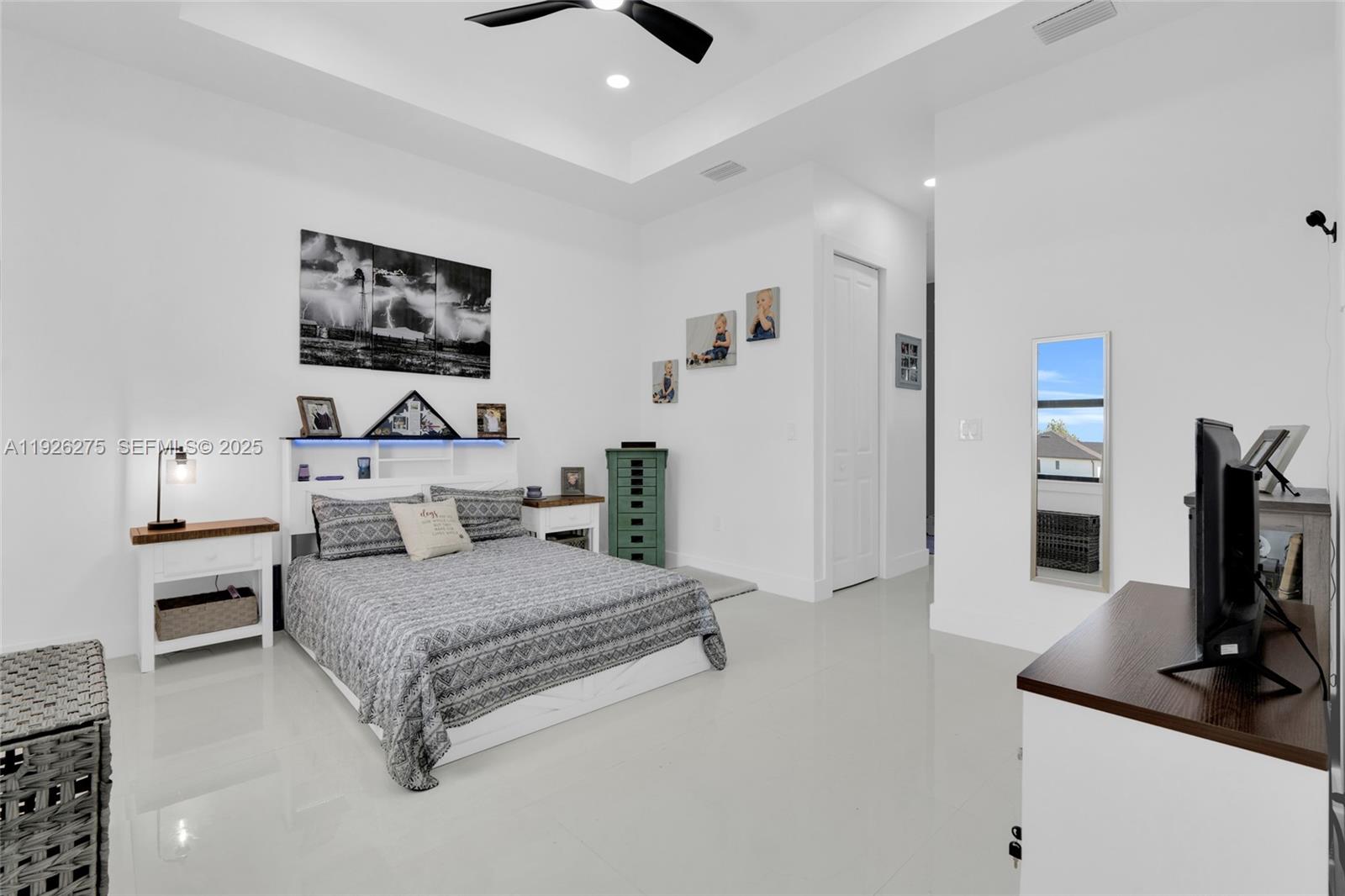 2250 10th Terrace Lehigh Acres, FL 33936 - Photo 10 of 39 a bedroom with a bed and a flat screen tv