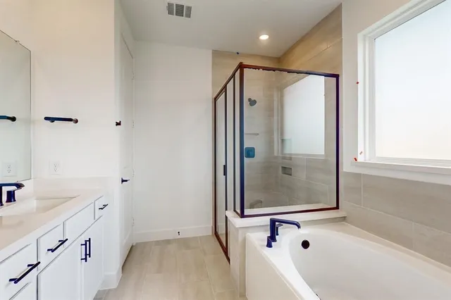 a bathroom with a bathtub and a shower