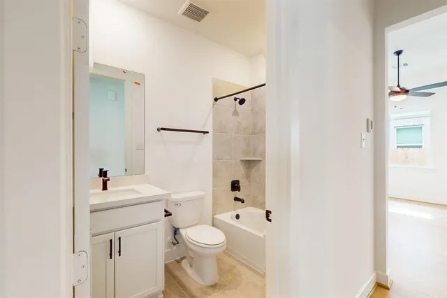 a white toilet sitting next to a bathroom sink