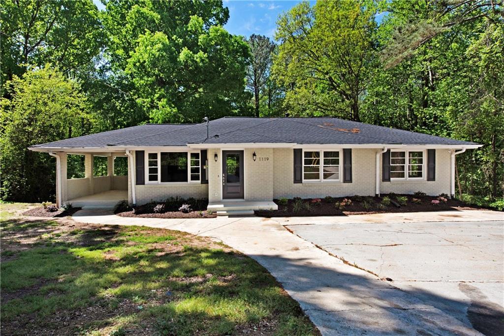 1119 Old Alabama Road Southwest Mableton, GA 30126 - Photo 1 of 1 a front view of a house with yard and green space