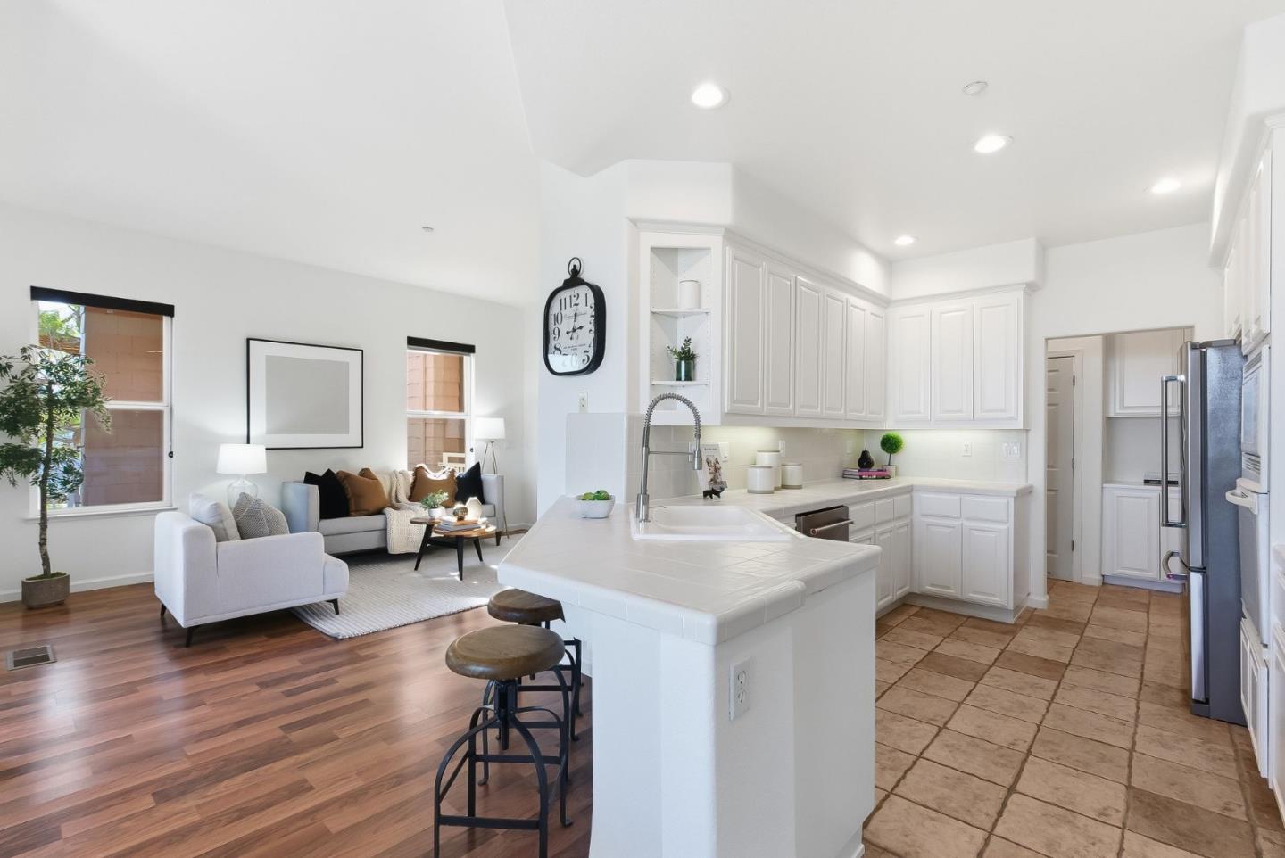 121 Cliff Swallow Court Brisbane, CA 94005 - Photo 15 of 50 a large white kitchen with a refrigerator a couch and a couch