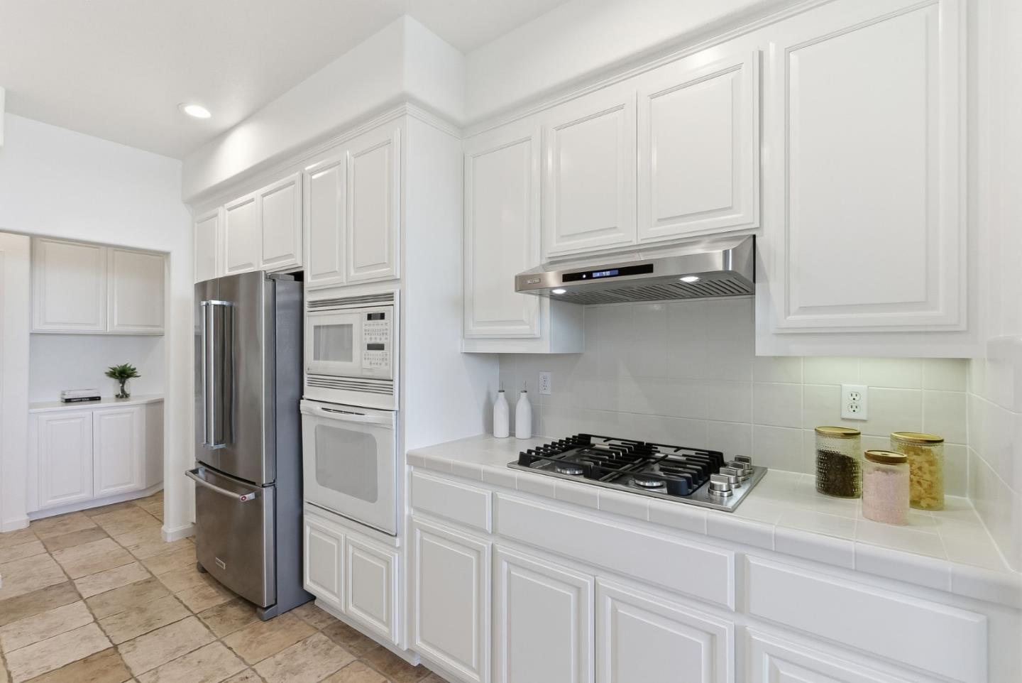 121 Cliff Swallow Court Brisbane, CA 94005 - Photo 19 of 50 a kitchen with stainless steel appliances granite countertop a refrigerator a stove and a sink