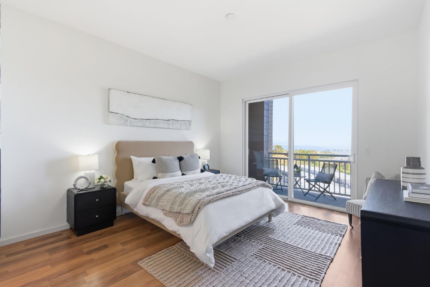 121 Cliff Swallow Court Brisbane, CA 94005 - Photo 21 of 50 a bedroom with a bed and a table