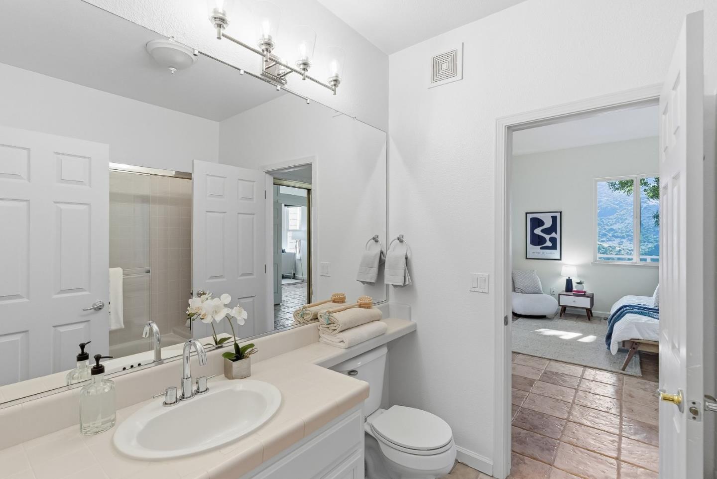 121 Cliff Swallow Court Brisbane, CA 94005 - Photo 34 of 50 a bathroom with a sink a toilet and a mirror